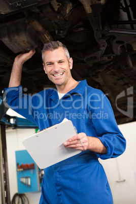 Mechanic examining under the car