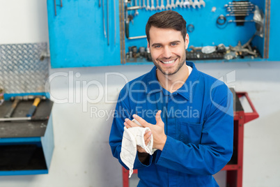 Smiling mechanic looking at camera