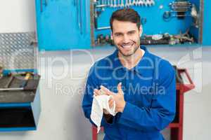 Smiling mechanic looking at camera