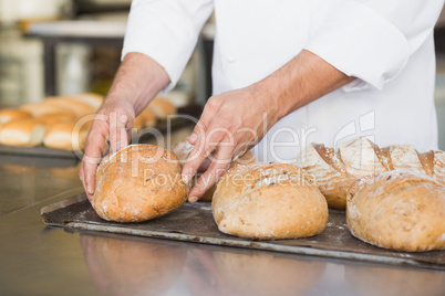 Baker checking freshly baked bread