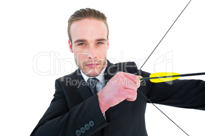Serious businessman shooting a bow and arrow