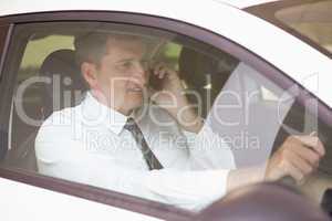 Smiling man on the phone in his car
