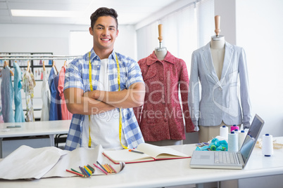 Smiling student posing with arms crossed