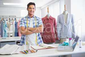 Smiling student posing with arms crossed