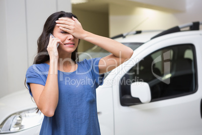 Sad woman calling someone with her mobile phone