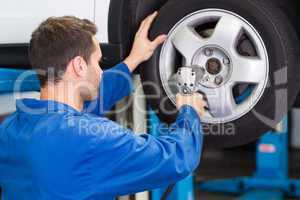 Mechanic adjusting the tire wheel