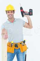 Carpenter showing thumbs up while holding drill machine