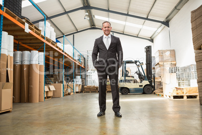 Warehouse manager standing with hands in the pocket