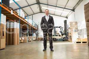 Warehouse manager standing with hands in the pocket