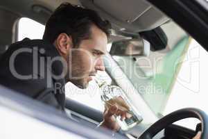Young businessman driving while drunk