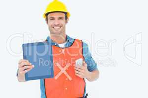 Carpenter holding digital tablet and mobile phone