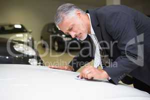 Focused cleaning a stain with his tie