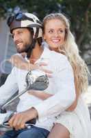 Cute couple riding a scooter