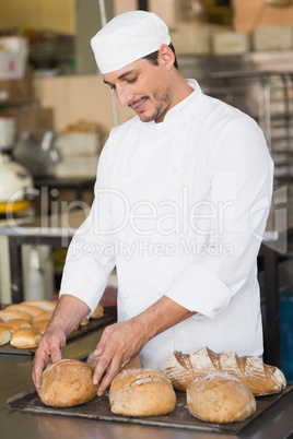 Baker checking freshly baked bread