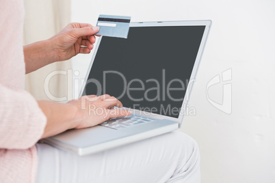 Woman shopping online with laptop