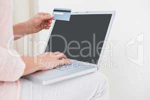 Woman shopping online with laptop