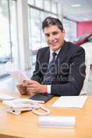 Smiling salesperson holding a document