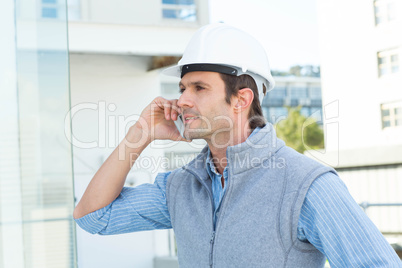 Architect using mobile phone outdoors