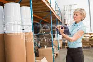 Female manager using digital tablet in warehouse