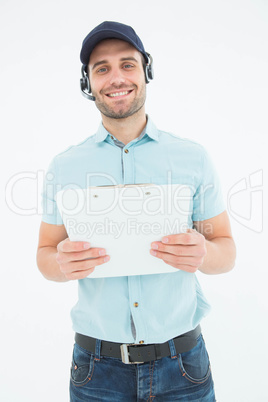 Courier man wearing headset while holding clipboard