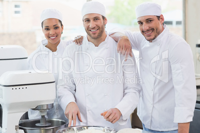 Team of bakers smiling at camera