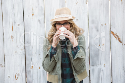 Portrait of blonde drinking from disposable cup