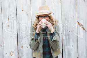 Portrait of blonde drinking from disposable cup