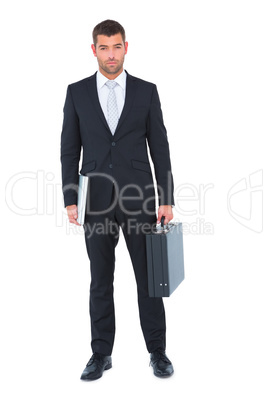 Businessman standing with his briefcase and documents