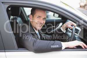 Happy businessman in the drivers seat