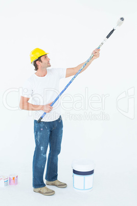 Side view of man painting on white background