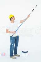 Side view of man painting on white background