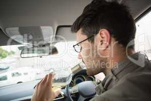 Man drinking wine while driving