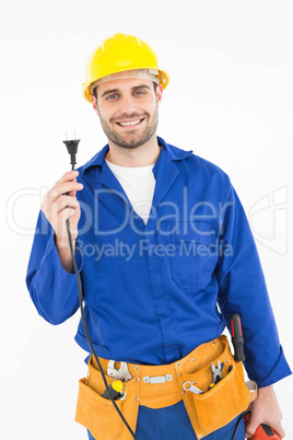 Smiling repairman holding electric plug