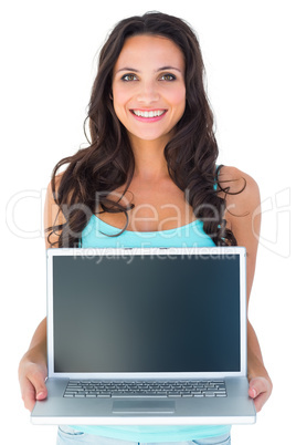 Casual brunette using her laptop