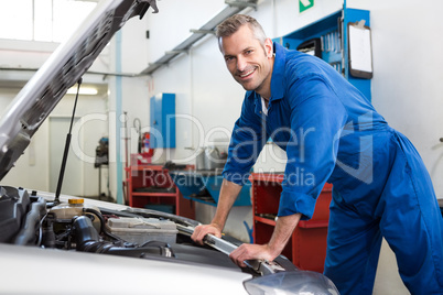 Mechanic working under the hood