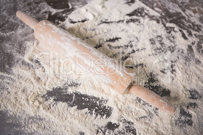 Close up of rolling pin in flour