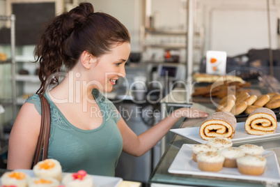 Pretty brunette looking at swiss roll