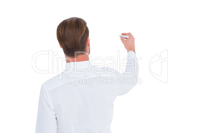 Rear view of businessman in shirt writing with chalk