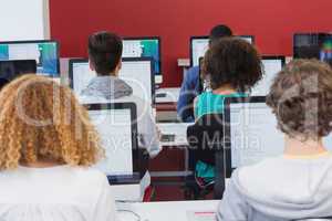 Student smiling at camera in computer class