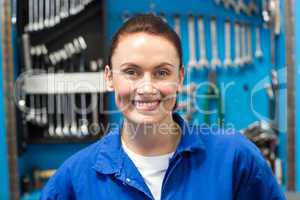 Smiling mechanic looking at camera