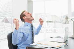 Businessman holding document cheering