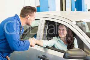 Customer shaking hands with mechanic