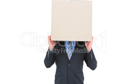 Businessman hiding head with a box