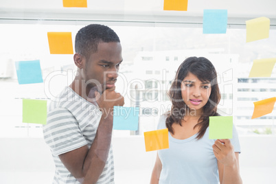 Concentrated coworkers reading sticky words