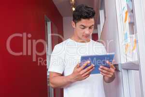 Cheerful student using tablet computer