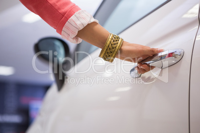 Woman holding a car door handles