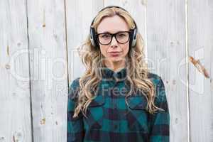 Serious blonde listening music with headphones