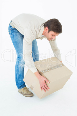 Courier man picking up cardboard box