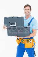 Confident carpenter opening tool box
