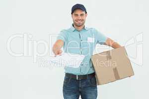 Delivery man with package giving clipboard for signature